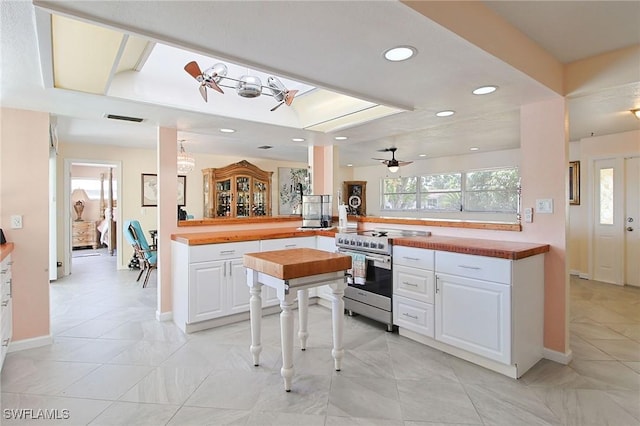 147 Coral Dr, Fort Myers, FL 33905 - kitchen featuring a wealth of natural light, white cabinets, stainless steel range with electric cooktop, and visible vents
