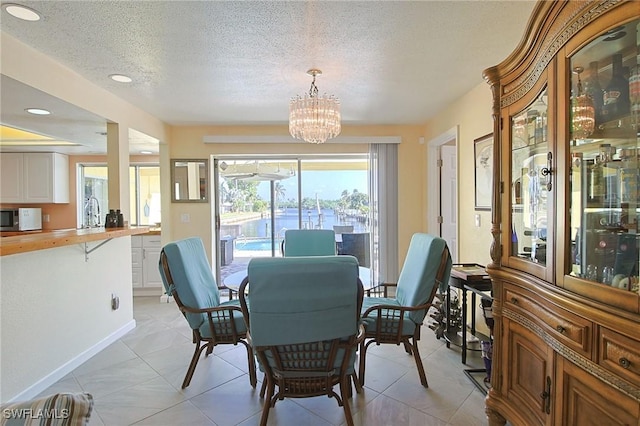 147 Coral Dr, Fort Myers, FL 33905 - dining room featuring recessed lighting, an inviting chandelier, light tile patterned flooring, and a textured ceiling
