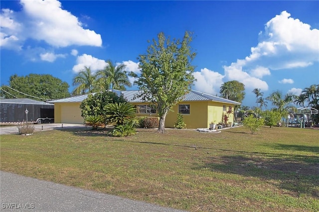 147 Coral Dr, Fort Myers, FL 33905 - view of front facade with metal roof, a front lawn, and driveway