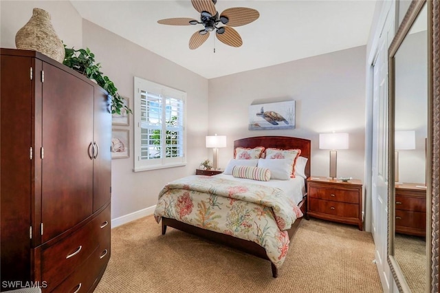 bedroom with baseboards, ceiling fan, and light carpet