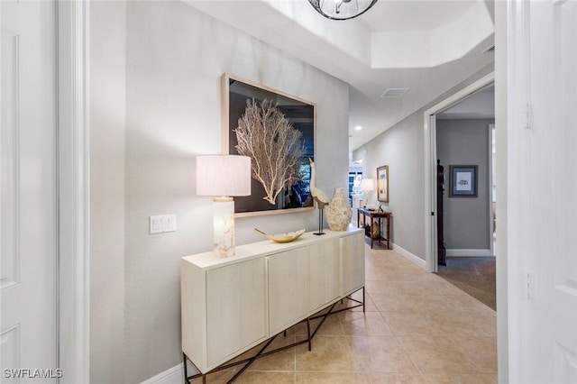 corridor with baseboards, recessed lighting, and light tile patterned flooring