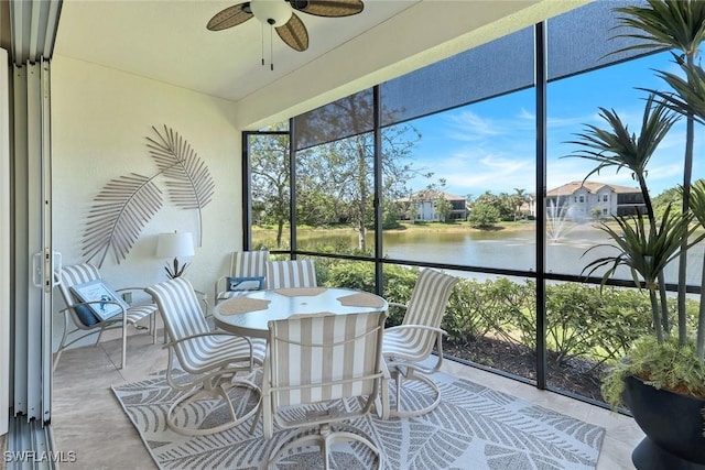 sunroom featuring a water view and a healthy amount of sunlight