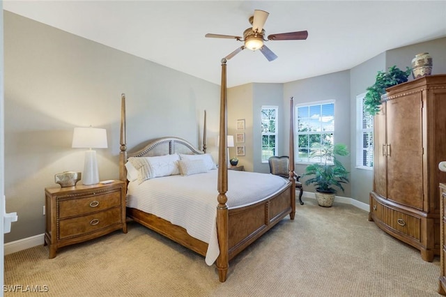 bedroom with baseboards, ceiling fan, and light carpet