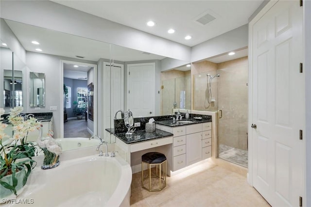 bathroom with a bath, a shower stall, vanity, tile patterned floors, and recessed lighting
