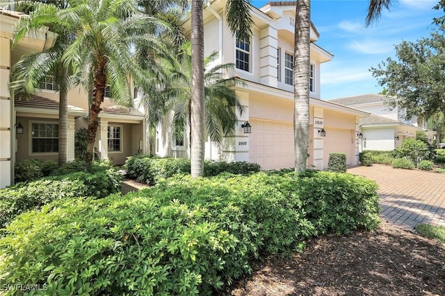 view of front of property with decorative driveway and stucco siding