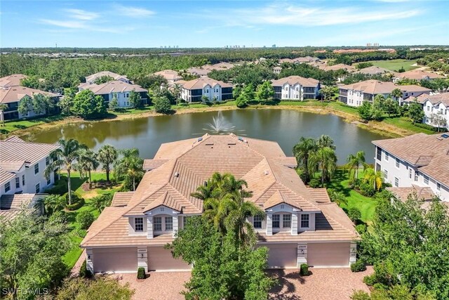 drone / aerial view featuring a water view and a residential view