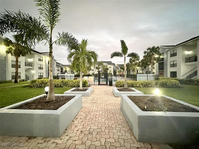 13515 Eagle Ridge Dr Unit 522, Fort Myers, FL 33912 - surrounding community with a lawn and fence