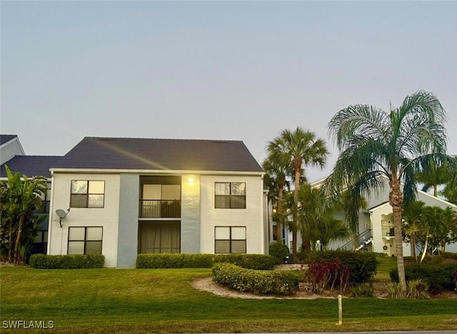 13515 Eagle Ridge Dr Unit 522, Fort Myers, FL 33912 - view of front of home featuring stucco siding and a front yard