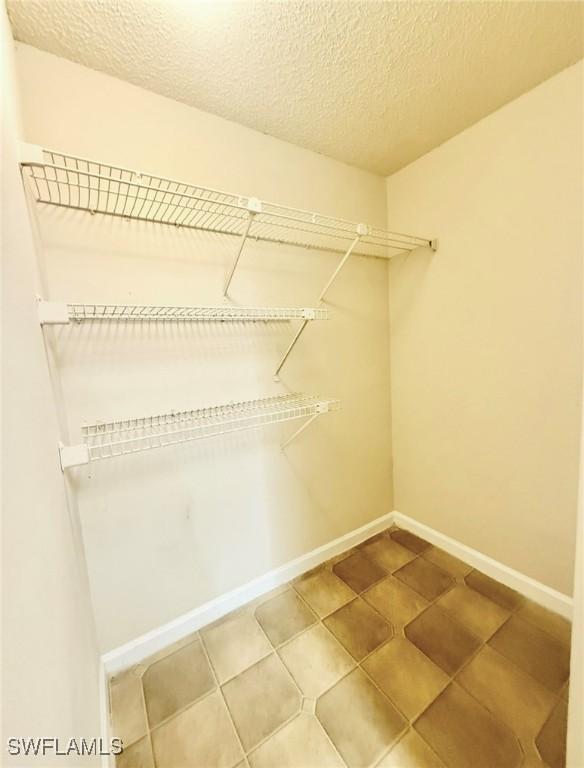 13515 Eagle Ridge Dr Unit 522, Fort Myers, FL 33912 - spacious closet featuring tile patterned flooring