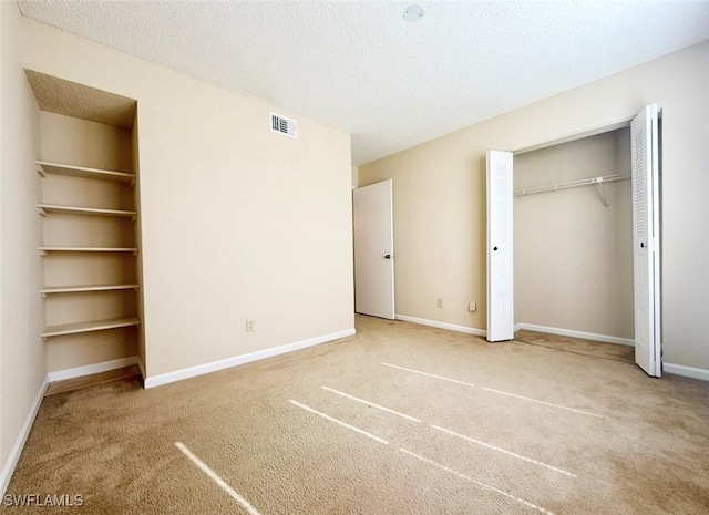 13515 Eagle Ridge Dr Unit 522, Fort Myers, FL 33912 - unfurnished bedroom featuring carpet floors, a textured ceiling, baseboards, and visible vents