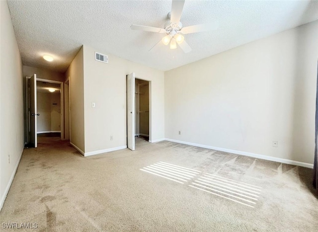 13515 Eagle Ridge Dr Unit 522, Fort Myers, FL 33912 - unfurnished bedroom featuring visible vents, a textured ceiling, a closet, and light colored carpet