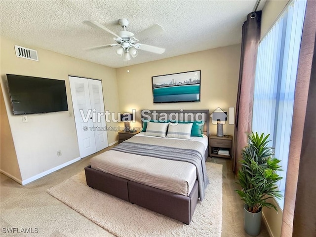 13515 Eagle Ridge Dr Unit 522, Fort Myers, FL 33912 - bedroom with a textured ceiling, visible vents, baseboards, carpet floors, and a closet