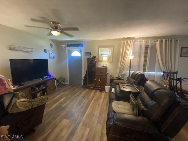 living room featuring a ceiling fan and wood finished floors