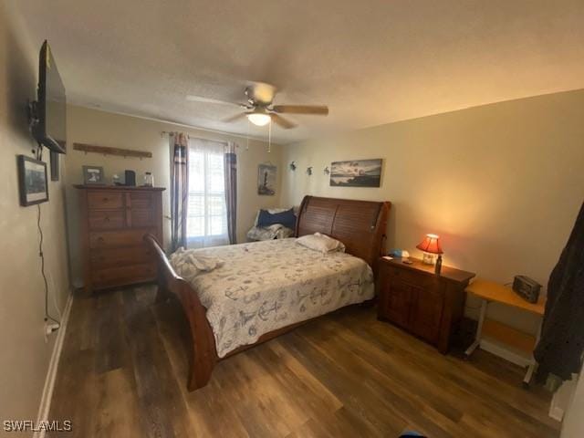 bedroom featuring baseboards, ceiling fan, and wood finished floors