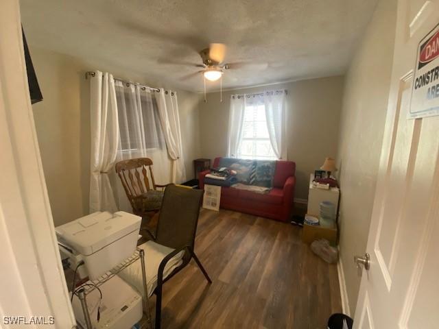 office space with ceiling fan and wood finished floors