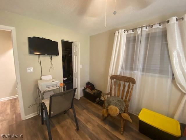 sitting room featuring baseboards and wood finished floors