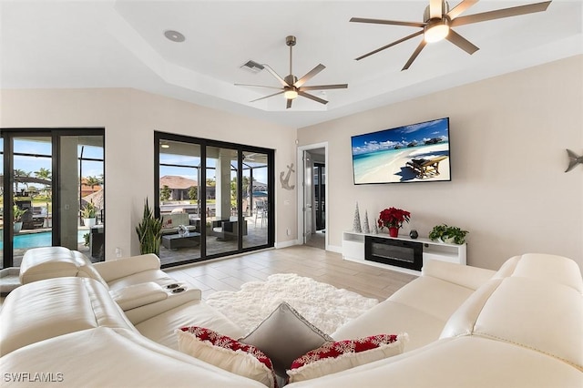 living area featuring baseboards, a ceiling fan, wood finished floors, and visible vents