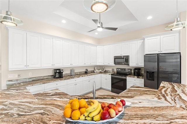 kitchen with a ceiling fan, appliances with stainless steel finishes, white cabinets, and light stone countertops