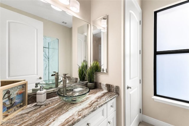 bathroom featuring vanity and visible vents