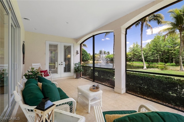 sunroom with an outdoor living space, french doors, and tile patterned flooring