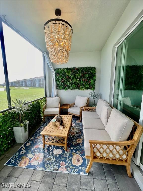 5445 Double Eagle Cir Unit 3012, Ave Maria, FL 34142 - sunroom with a chandelier
