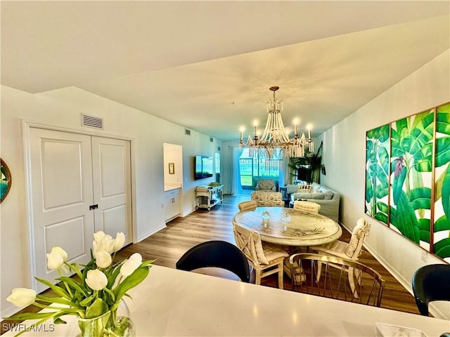 5445 Double Eagle Cir Unit 3012, Ave Maria, FL 34142 - dining space featuring a chandelier, wood finished floors, and baseboards