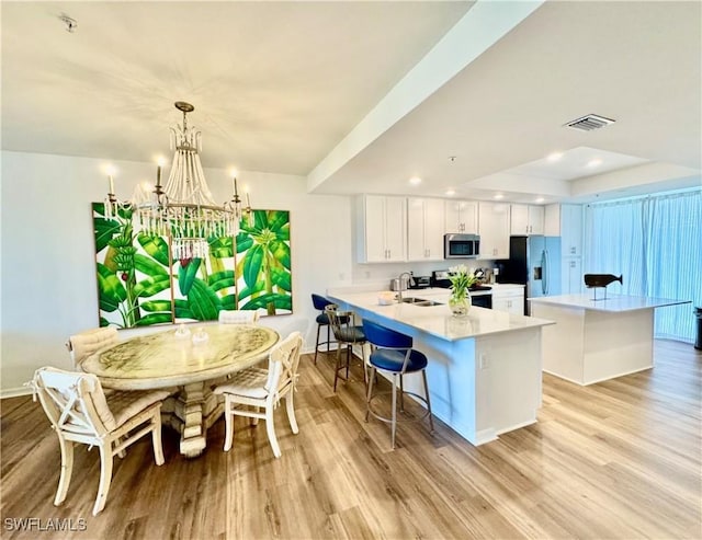 5445 Double Eagle Cir Unit 3012, Ave Maria, FL 34142 - kitchen with stainless steel appliances, a sink, light wood-type flooring, a chandelier, and recessed lighting