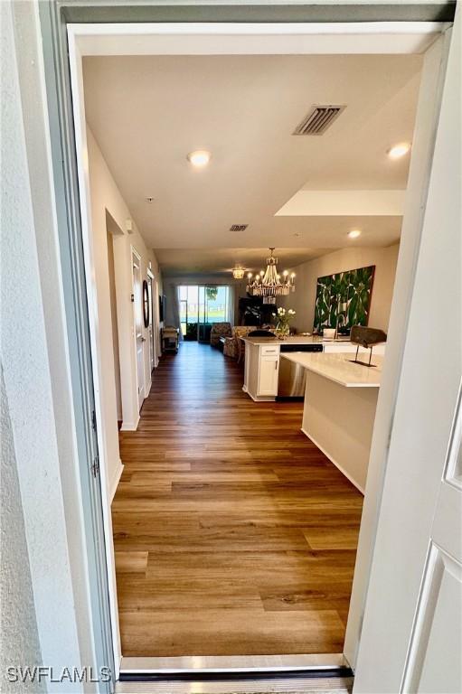 5445 Double Eagle Cir Unit 3012, Ave Maria, FL 34142 - corridor with dark wood-style floors, a chandelier, and recessed lighting