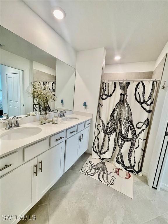 5445 Double Eagle Cir Unit 3012, Ave Maria, FL 34142 - full bath featuring double vanity and a shower with shower curtain