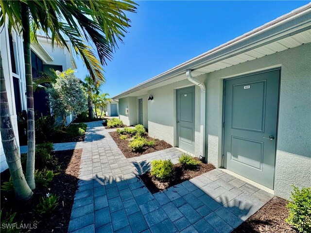 5445 Double Eagle Cir Unit 3012, Ave Maria, FL 34142 - doorway to property featuring stucco siding