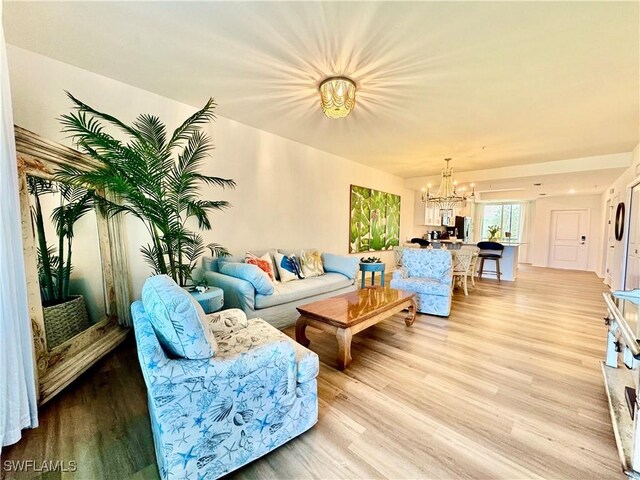 5445 Double Eagle Cir Unit 3012, Ave Maria, FL 34142 - living room featuring a chandelier and light wood-style floors