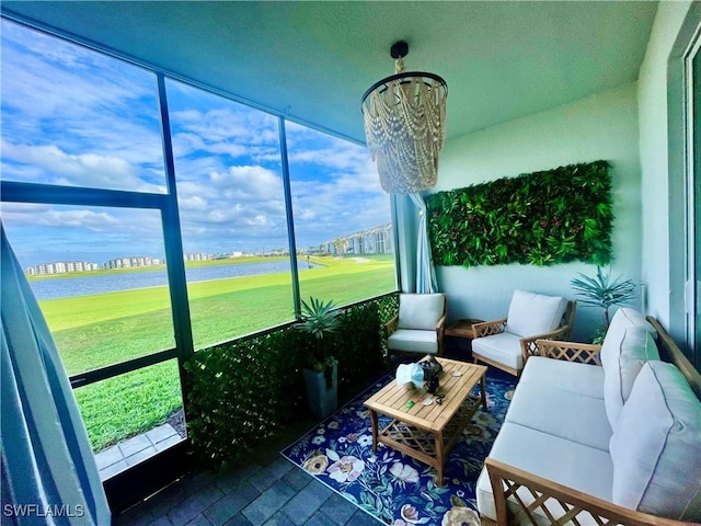 5445 Double Eagle Cir Unit 3012, Ave Maria, FL 34142 - sunroom featuring a water view, golf course view, and a chandelier