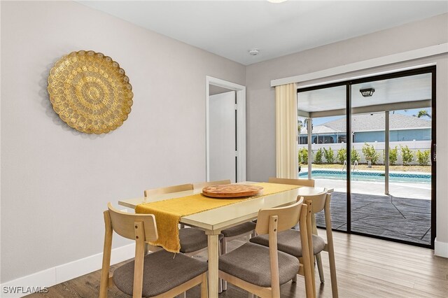 1424 SW 49th St, Cape Coral, FL 33914 - dining space featuring baseboards and light wood-type flooring