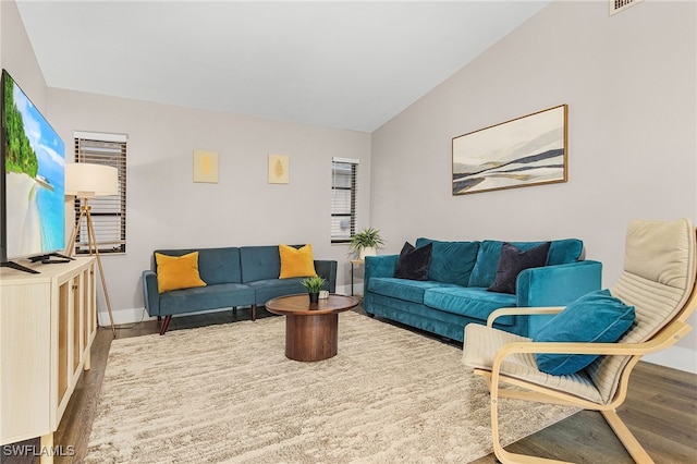 1424 SW 49th St, Cape Coral, FL 33914 - living room featuring wood finished floors, baseboards, and vaulted ceiling