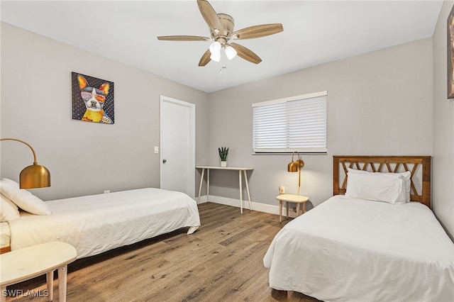 1424 SW 49th St, Cape Coral, FL 33914 - bedroom with wood finished floors, baseboards, and a ceiling fan
