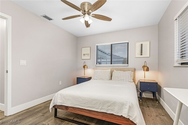 1424 SW 49th St, Cape Coral, FL 33914 - bedroom featuring wood finished floors, baseboards, and ceiling fan