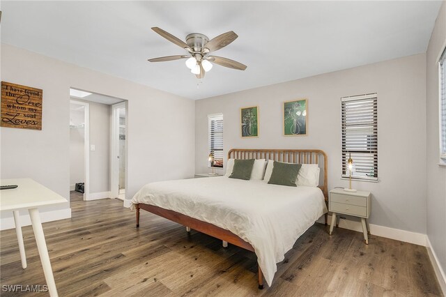 1424 SW 49th St, Cape Coral, FL 33914 - bedroom with baseboards, wood finished floors, and multiple windows