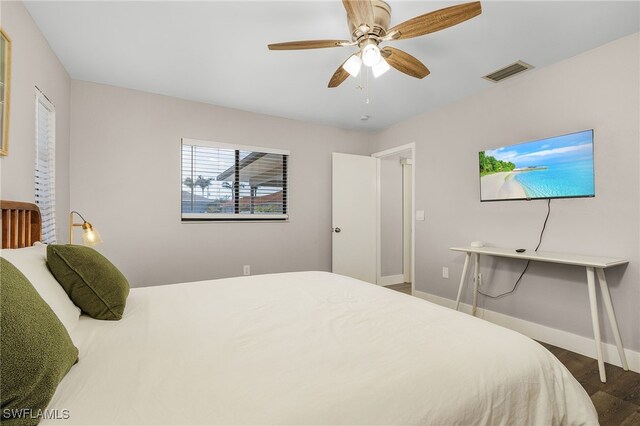 1424 SW 49th St, Cape Coral, FL 33914 - bedroom with wood finished floors, baseboards, and a ceiling fan