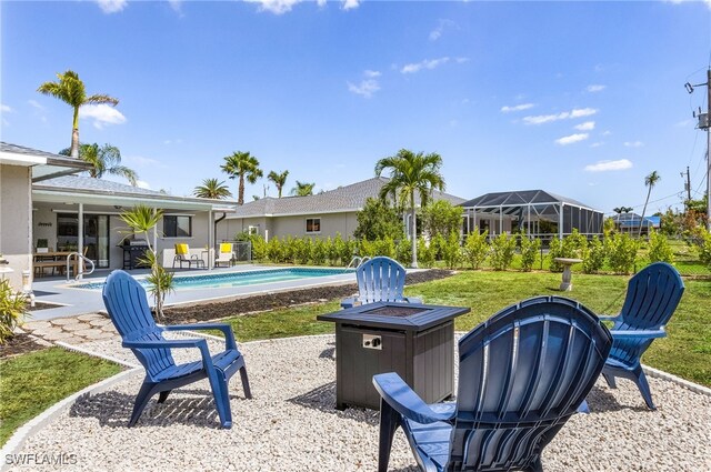 1424 SW 49th St, Cape Coral, FL 33914 - view of green lawn with an outdoor pool, a patio area, and an outdoor fire pit