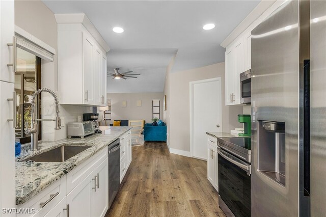 1424 SW 49th St, Cape Coral, FL 33914 - kitchen featuring appliances with stainless steel finishes, a sink, white cabinetry, a ceiling fan, and recessed lighting
