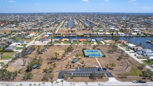 1424 SW 49th St, Cape Coral, FL 33914 - aerial view of property and surrounding area featuring nearby suburban area and a large body of water