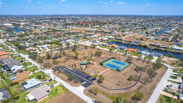 1424 SW 49th St, Cape Coral, FL 33914 - aerial view of property and surrounding area with nearby suburban area and a large body of water