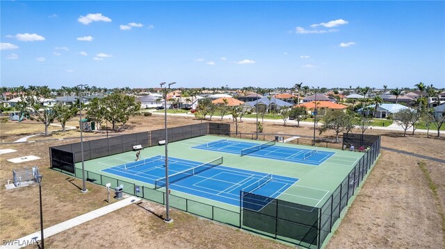 1424 SW 49th St, Cape Coral, FL 33914 - view of tennis court featuring a residential view