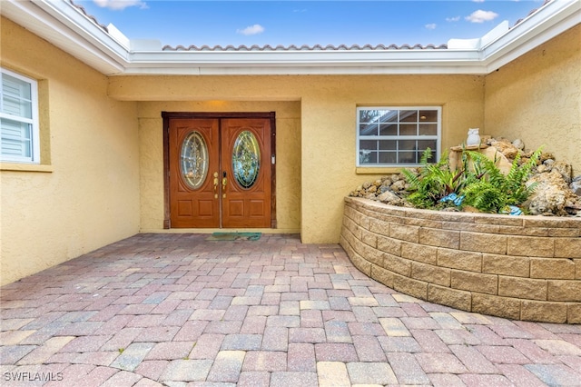 5122 Santa Rosa Ct, Cape Coral, FL 33904 - doorway to property featuring stucco siding
