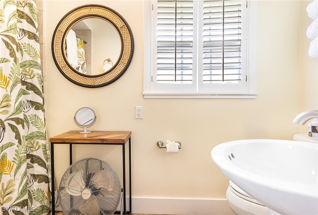 5122 Santa Rosa Ct, Cape Coral, FL 33904 - bathroom with a shower with shower curtain, baseboards, and a sink