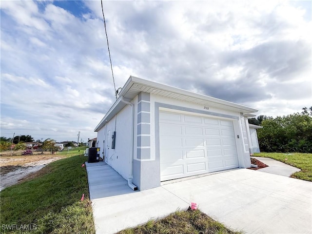 2703 42nd St SW, Lehigh Acres, FL 33976 - view of side of home with concrete driveway, stucco siding, cooling unit, and an attached garage