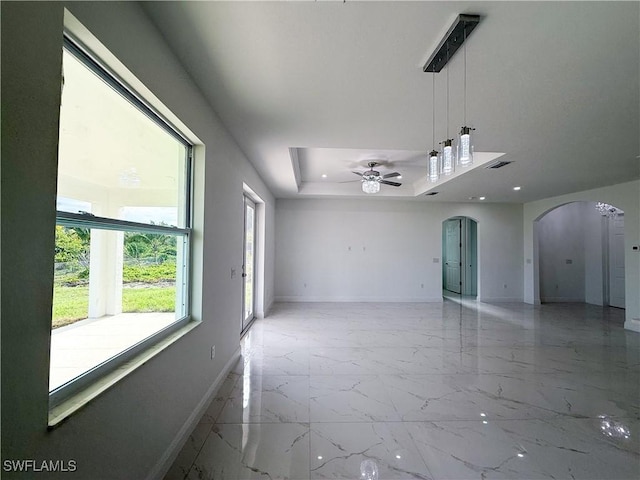 2703 42nd St SW, Lehigh Acres, FL 33976 - empty room with arched walkways, baseboards, light marble finish floors, a ceiling fan, and recessed lighting