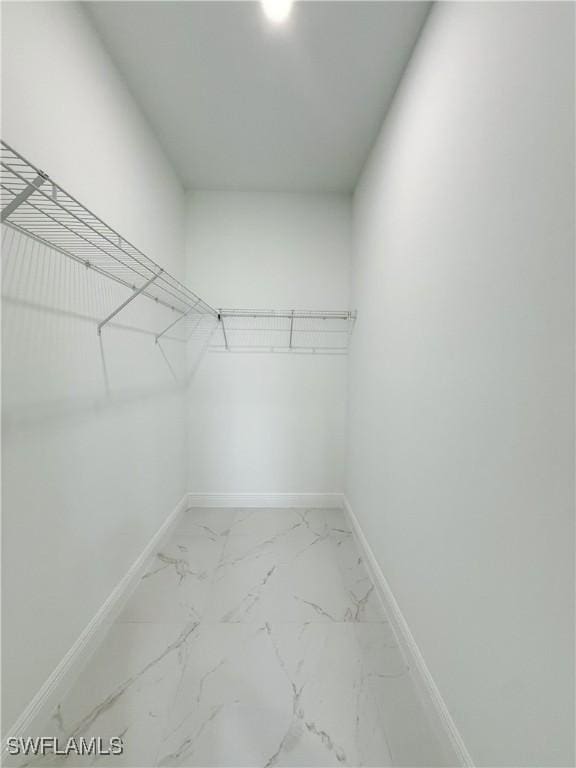 2703 42nd St SW, Lehigh Acres, FL 33976 - spacious closet featuring marble look tiles