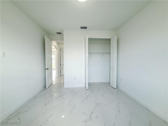 2703 42nd St SW, Lehigh Acres, FL 33976 - unfurnished bedroom with baseboards, light marble finish floors, and a closet