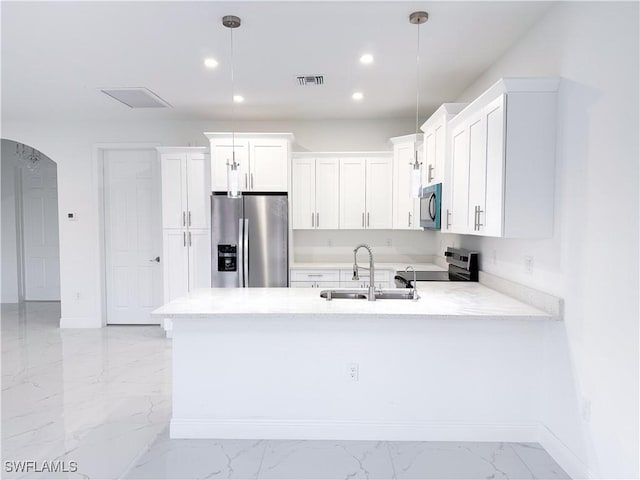 2703 42nd St SW, Lehigh Acres, FL 33976 - kitchen with appliances with stainless steel finishes, a sink, light marble finish floors, a peninsula, and baseboards